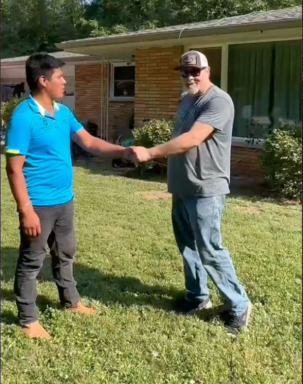 Roofer standing with customer for review